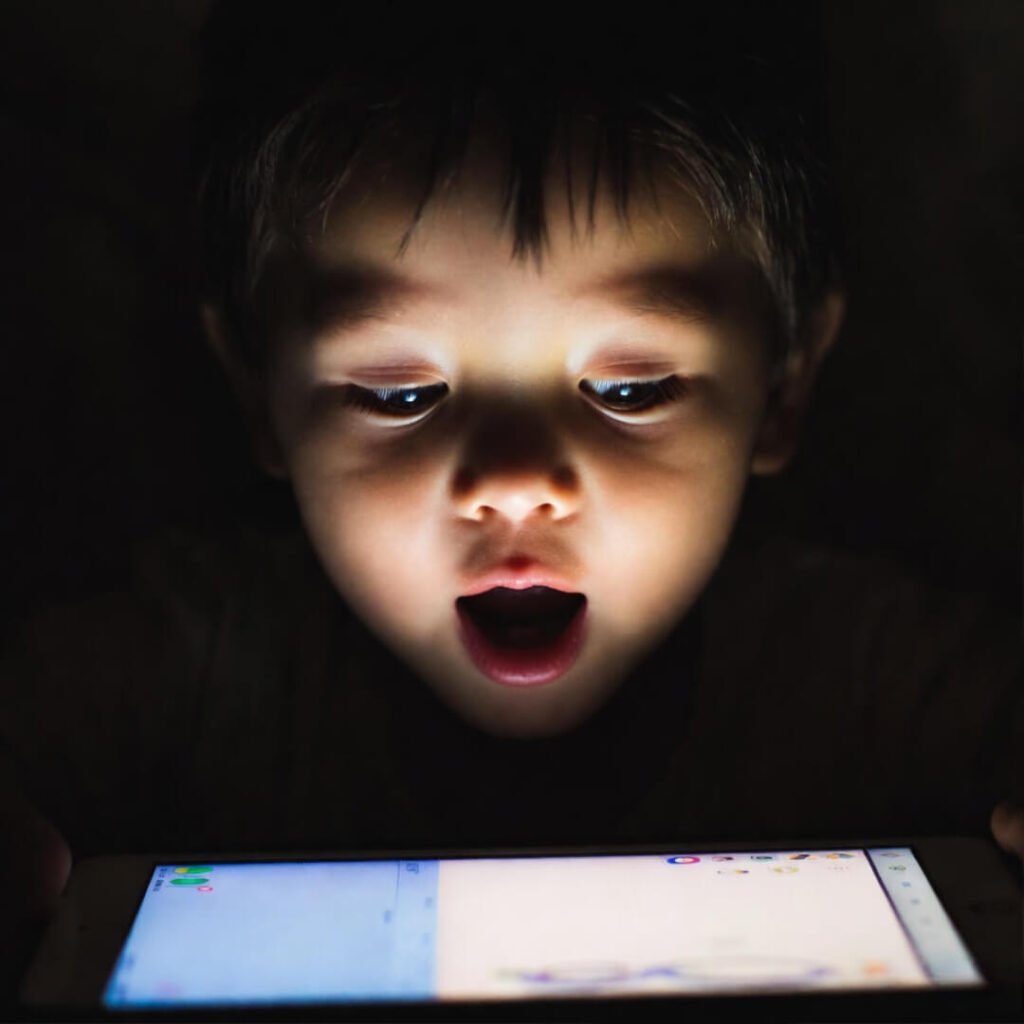 Kid's eureka face, tablet glow.