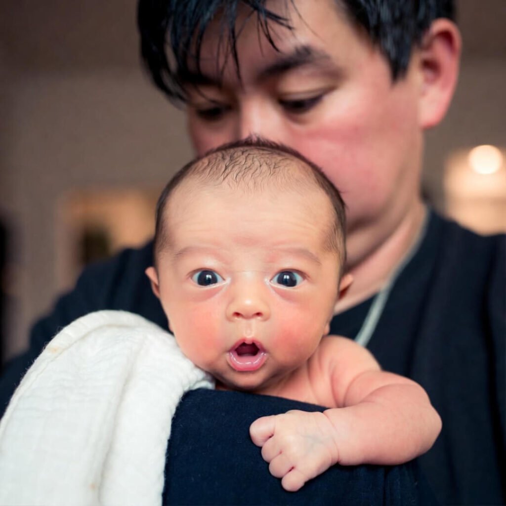 Burping baby over shoulder, messy moment.