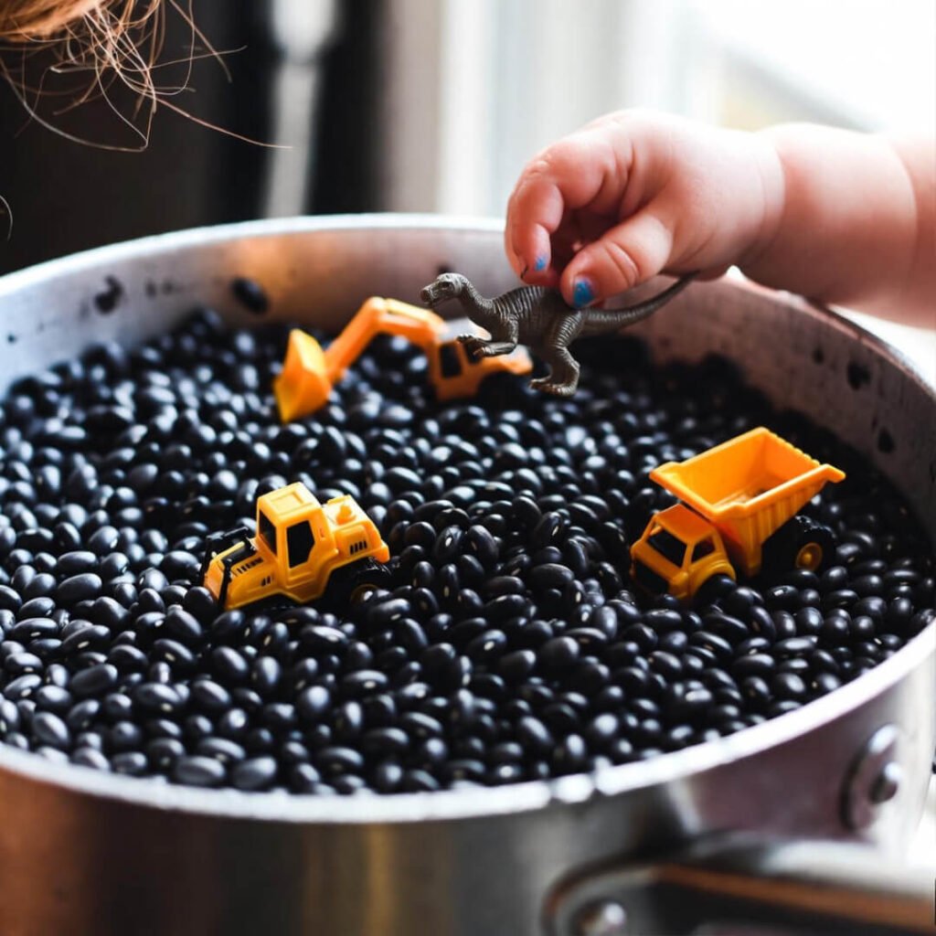 Toddler dropping dinosaur into black bean construction site